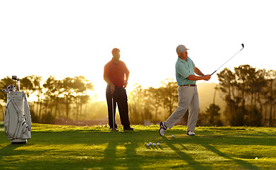 Image showing Sunset, golf and men on a course for training, competition or professional game. Fitness, summer and friends on the grass golfing during retirement for holiday, hobby and recreation at a club