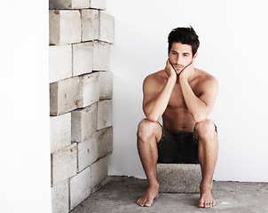 Image showing Thinking, sexy man with serious look and wall background with beauty, glow and confidence. Attractive, confident and sensual face of male model on brick backdrop in morning with thoughtful expression