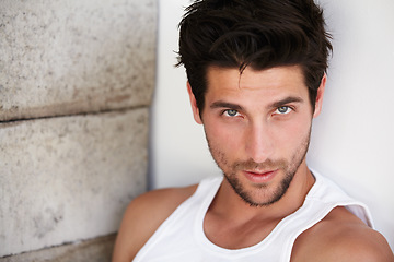 Image showing Portrait of handsome man, sexy look and wall background with beauty, glow and confidence. Attractive, confident and serious face of male model on brick backdrop in morning with thoughtful expression.