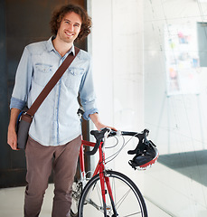 Image showing Portrait, bicycle and business man in office for creative startup, happy career and internship opportunity. Young person, designer or employee with bike, carbon footprint and startup job in workplace