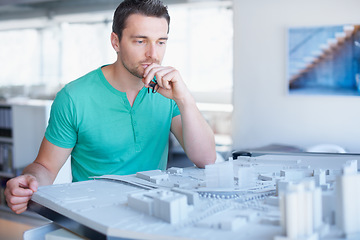 Image showing Architecture, model and business man thinking, planning and building development or infrastructure solution. Engineering, ideas and problem solving of designer, contractor or person with 3d project