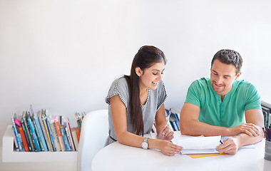 Image showing Collaboration, planning and design with a creative team talking while reading documents in their office. Teamwork, meeting or strategy with a man and woman designer in discussion over creativity