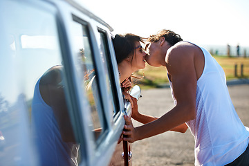 Image showing Kiss, love and a couple on a road trip in a van for a holiday, adventure or a drive. Care, romantic and a man and woman kissing in nature with transportation for a honeymoon vacation or date