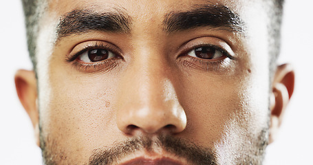 Image showing Closeup, face and serious man in studio for skincare, confident and handsome against white background. Zoom, young and portrait of Indian male model with wellness, beauty or cosmetic routine isolated