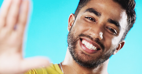 Image showing Selfie, laughing and face of a man with a smile isolated on a blue background in a studio. Happy, cheerful and portrait of a young guy taking a photo, smiling and posing for a picture on a backdrop