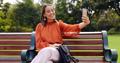 Image showing Selfie, smile and Asian woman on bench at park taking pictures for social media. Summer, profile picture and person sitting outdoor taking photo for happy memory, tongue out or funny face alone.