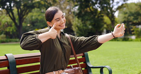 Image showing Selfie, hand gesture and woman on bench at park taking pictures for social media influencer. Summer, profile picture and person sitting outdoor taking photo for happy memory, peace sign and thumbs up