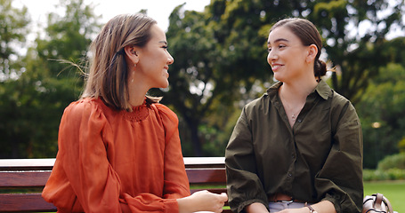 Image showing Friends, women and laughing at park on bench, bonding and talking together. Girls, outdoor and happiness of people in conversation, comic discussion or comedy and enjoying quality time for friendship