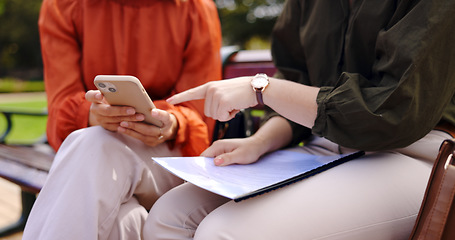 Image showing Business, closeup and women on a bench, smartphone or planning for collaboration, documents or discussion. Female professionals, freelancers or partners in a park, cellphone or mobile app for project