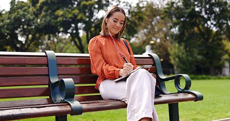 Image showing Business, planning and woman on a bench, writing and inspiration with lady outdoor, smile and brainstorming. Female freelance, happy entrepreneur or professional with a notebook or listening to music