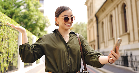 Image showing Travel, video call and woman outdoor, smile or wave in street, tourist or excited for adventure. Female person, traveler sightseeing or girl with smartphone, live streaming or online for social media