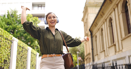 Image showing Happy, dance and woman in city, headphones and celebrate in street, cheerful and inspiration. Female person, person and girl with headset, dancing and movement in town, listening to music and radio