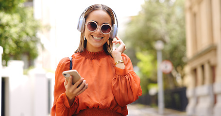 Image showing Music headphones, phone and woman dancing in city, having fun or happiness outdoor. Cellphone, dancer and happy person listening, streaming and enjoying radio, audio or sound podcast in urban street.