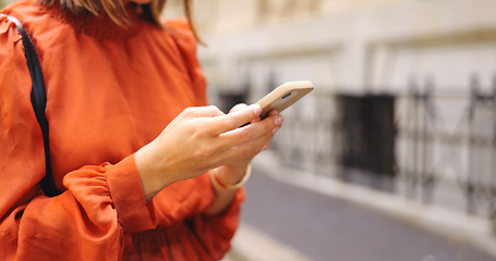 Image showing Hands, typing and phone in city for social media, online browsing or web scrolling in urban street. Cellphone, woman and person text messaging, networking on app and internet search outdoor in town.