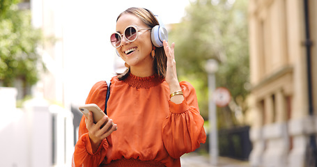 Image showing Phone, music and woman dance in a city with headphones, happy and good mood outdoors. Radio, street and asian female dancing to podcast , excited and cheerful, free or positive in London