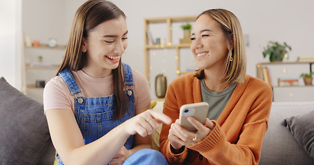 Image showing Happy, friends and women on sofa, cellphone and online reading with social media, joyful and relax in living room. Females, girls and smartphone in lounge, search internet for videos or rest together