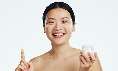 Image showing Face, lotion and beauty of asian woman, studio and isolated white background of aesthetic cosmetics. Portrait, facial cream and skincare jar of female model, sunscreen and happy dermatology product