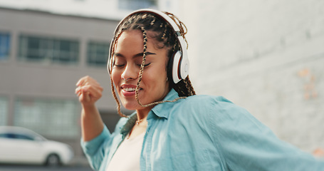 Image showing Woman, dancing and listening to music in the city with headphones for audio streaming in the outdoors. Happy female dancer enjoying 5G connection with headset to listen for sound track in urban town