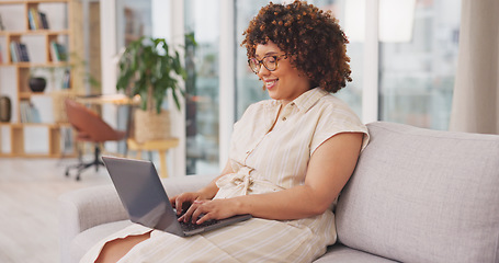 Image showing Female entrepreneur, happy freelancer and consultant in living room, device and website launch. Startup, woman on couch and laptop for remote work from home, connection and typing for data analysis.