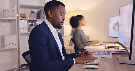 Image showing Business, night and black man typing on computer in office working late for planning, proposal and project. Corporate, focus and male worker at desk for writing email, website research and report