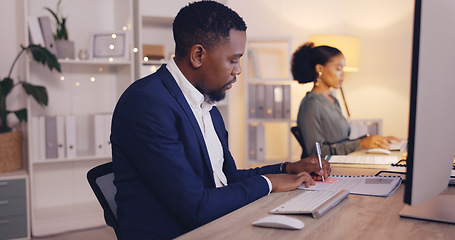 Image showing Business, writing and black man with notebook by computer working late for planning, proposal and project. Corporate, focus and male worker at desk schedule, website research and online report notes