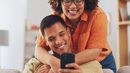 Image showing Love, hug diversity, happy couple on sofa with phone, happiness and marriage in apartment. Smile, man and woman embrace on couch in living room, romance and quality time for bonding together in home.