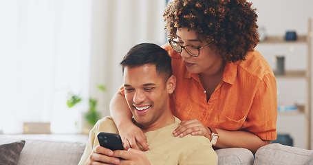 Image showing Social media joke, phone and happy couple on sofa with smile, laugh and internet meme in apartment. Happiness, man and woman on couch in living room, laughing and checking funny post online together.