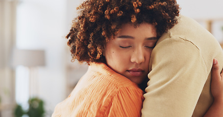 Image showing Love, care and support with a couple hugging in the living room of their home together for comfort or trust. Empathy, console or marriage with a man and woman embracing through pain, loss or grief