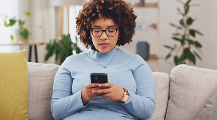 Image showing Serious, phone and relax with woman on sofa for social media, internet and text message. Search, typing and technology with female in living room at home for communication, connection and digital app