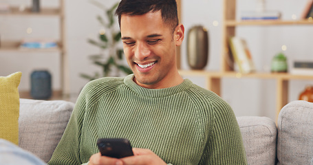 Image showing Laughing, phone and relax with man on sofa for social media, internet and text message. Happy, smile and technology with male in living room at home for communication, connection and digital app