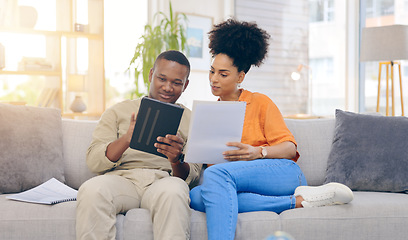 Image showing Tablet,documents, smile and couple on sofa in home living room, bonding and online shopping. Interracial, technology and happy black man and woman relax on social media, internet browsing or web scro