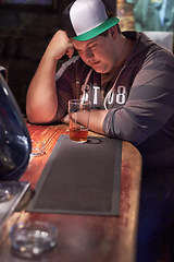 Image showing Beer, pub alcohol and sad man depression over emotional crisis, worry or health risk at restaurant, diner or bar. Plus size, drink and drunk person depressed over fail, lonely or thinking of decision