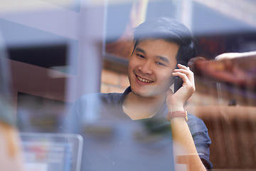 Image showing Phone call, cafe window and Asian man in networking conversation with laptop, smile and online meeting. Happy tech consultant, startup and young businessman with cellphone, discussion and reflection