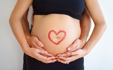 Image showing Closeup, pregnant and woman with heart, stomach and bonding with nurture, health and wellness. Zoom, couple and hands with love symbol, support and belly with childcare, pregnancy and wellness