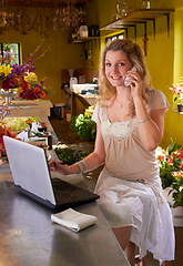 Image showing Florist woman, phone call and portrait with laptop, smile or communication in store for flowers. Small business owner, talking and happy for networking by computer, plants and retail customer service