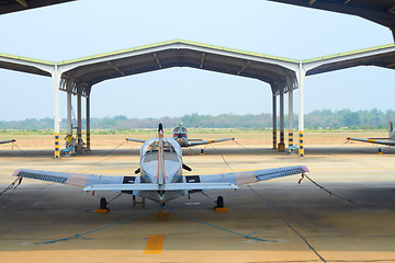 Image showing Flight, military and hangar with plane at airport for rescue mission, transportation and emergency. Wings, airforce service and flying with fighter jet on runway for cargo, pilot and journey