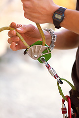 Image showing Hand, closeup and rock climbing in safety harness for adventure, hiking or outdoor gear in summer. Hiker, rope knot or mountaineer in nature for exercise, training or fitness for freedom in sunshine