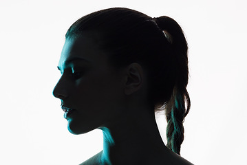 Image showing Silhouette, studio and face of a woman on a white background with shadow and neon or creative glow in profile. Fantasy, light and shine of female model and side of person with art or dark aesthetic