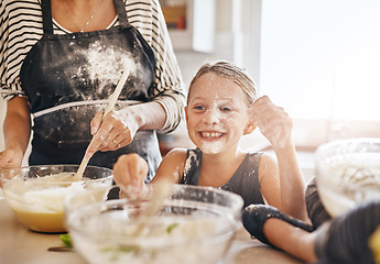 Image showing Mom, playing or happy girl baking in kitchen as a happy family with a playful young kid with flour at home. Dirty, messy or mom helping, cooking or teaching fun daughter to bake for child development