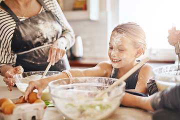 Image showing Learning, playing or messy kid baking in kitchen with a young girl smiling with flour on a dirty face at home. Smile, happy or parent cooking or teaching a fun daughter to bake for child development