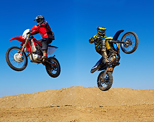 Image showing Motorcycle jump, sport and action with stunt and energy on off road track, transportation and people race outdoor. Competition, dirt bike and performance with adrenaline, exercise and challenge