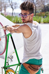 Image showing Man, cool style and portrait with bike in city, outdoor and sunglasses for unique street fashion. Young gen z guy, funky male hipster and cycling on bicycle in summer, urban town and with attitude