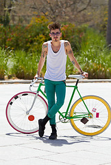 Image showing Portrait, bike and a hipster man in the city for eco friendly travel, sustainability or carbon neutral transportation. Fashion, retro and a cyclist standing with a vintage bicycle in an urban town