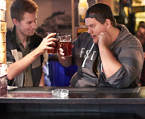 Image showing Friends, beer and cheers with man at pub for conversation, social and alcohol. Nightlife, toast and restaurant with people talking at table in bar for discussion, celebration and weekend gathering