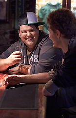 Image showing Friends, beer and happy with man at pub for conversation, social and alcohol. Nightlife, relax and restaurant with people drinking at table in bar for discussion, brewery and weekend gathering