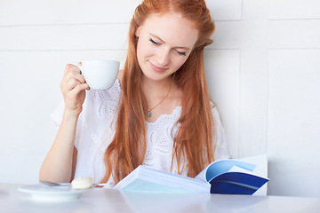 Image showing Drinking coffee, relax and woman reading a book, break or lady with a hobby, home or peace. Female person, calm or girl with a novel, literature or tea with espresso, story or thinking with knowledge