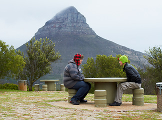 Image showing Mountain, people and relax at table, bench or rest in nature, hike and hikers talking with view, landscape and natural beauty. Outdoor, mountains and man or friends in conversation in park and winter