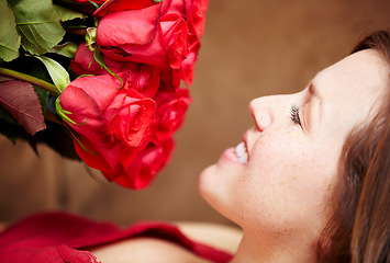 Image showing Woman, smell roses and smile for valentines day gift, present and celebration of love, floral fragrance and bouquet. Happy female person, face and red flowers of plants in bloom, blossom and perfume