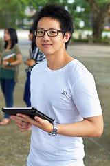 Image showing Asian man, college student and tablet in outdoor portrait with smile for study, education and social media app. Japanese gen z person, digital touchscreen and learning at university, campus or school