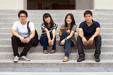 Image showing Asian friends, portrait and university on stairs with smile, learning or gen z fashion at campus in Tokyo. Young student group, Japanese men and women with books, education or relax outdoor on steps